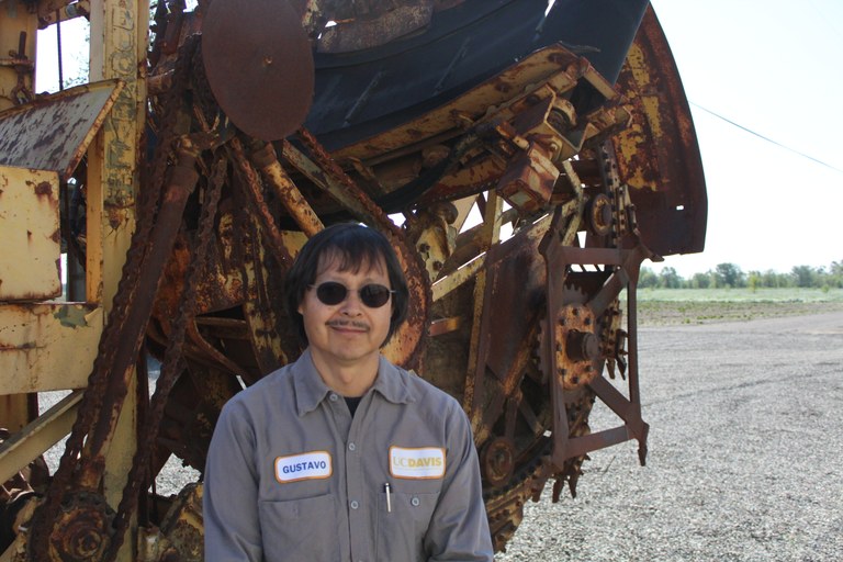 Gustavo Morales in front of the out of commission trencher he'll work to restore.
