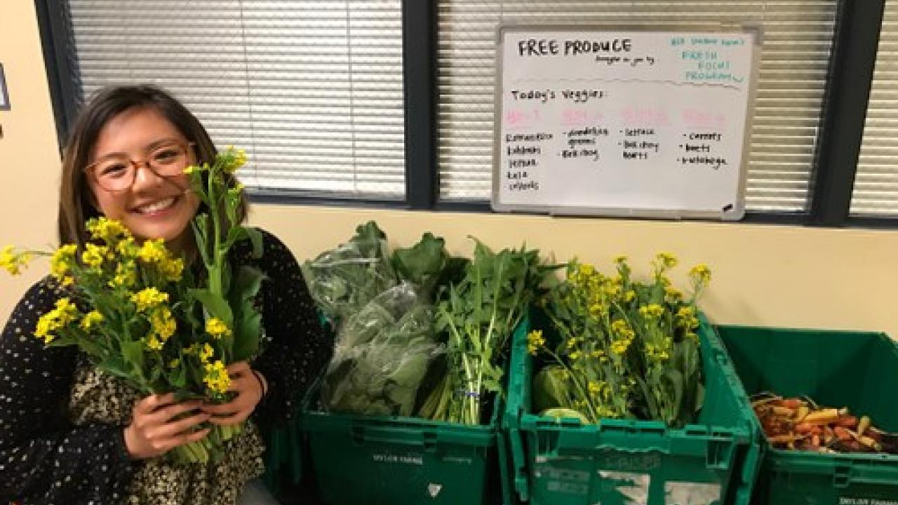 Fresh Focus coordinator Dana Ng showcasing Student Farm produce at the ASUCD Pantry