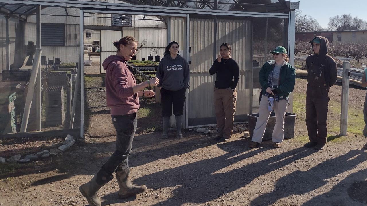 Jan teaching in front of the greenhouse