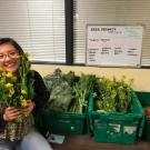 Fresh Focus coordinator Dana Ng showcasing Student Farm produce at the ASUCD Pantry