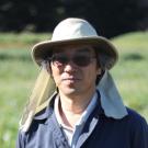 Joji Muramoto outdoors in a field